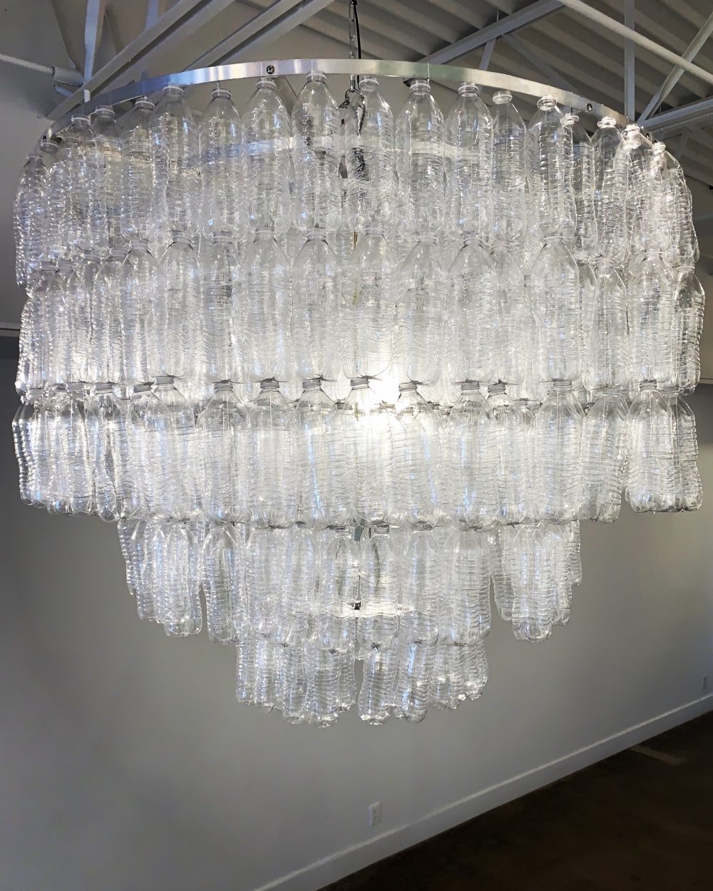 chandelier made from found plastic bottles on the beach by shelia rogers | Felder Gallery